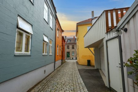 Photo for The street in the residential district Bakklandet in Trondheim , the popular touristic area with colorful wooden houses - Royalty Free Image