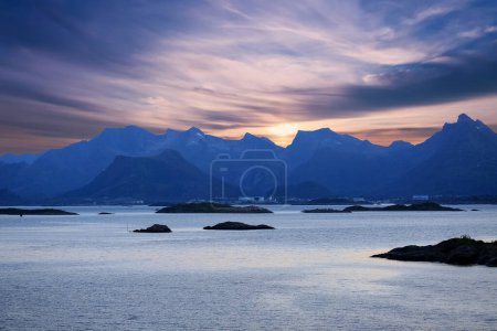 Photo for Midsummer sun on the sky in the fjord Vestfjorden near the Lofoten islands and town Svolvaer, Norway - Royalty Free Image