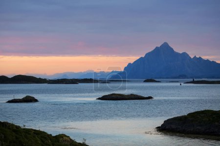 Photo for Midsummer sunlight on the sky in the fjord Vestfjorden near the Lofoten islands and town Svolvaer, Norway - Royalty Free Image