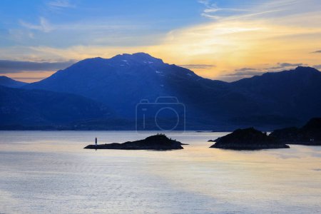 Photo for Midsummer sun on the sky in the fjord Vestfjorden near the Lofoten islands and town Svolvaer, Norway - Royalty Free Image