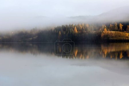 Foggy sunset in November at the lake Jonsvatnet located in Trondheim municipality, Norway