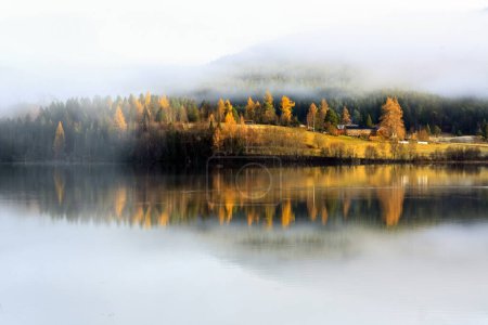 Foggy sunset in November at the lake Jonsvatnet located in Trondheim municipality, Norway