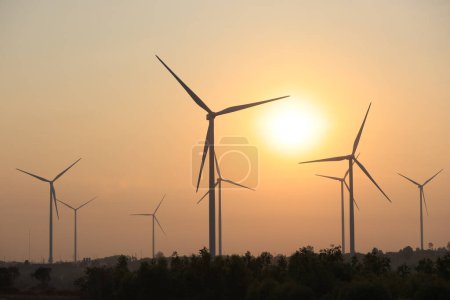 Silhouette windmill or Wind Turbine farm against sun rise sky, Eco green energy, renewable energy.