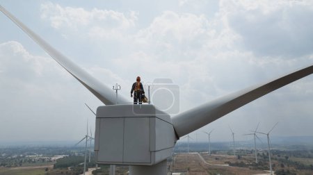 Photo for Wind turbine Engineer work on Top of Wind Turbines, maintenance service , Green energy - Royalty Free Image