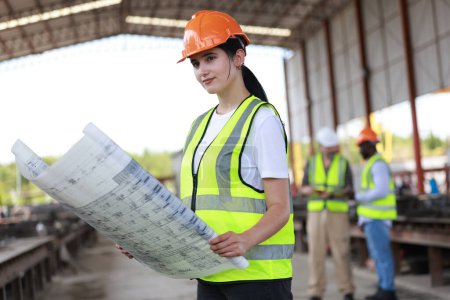 Photo for Female Civil engineer works with colleagues at precise factory - Royalty Free Image