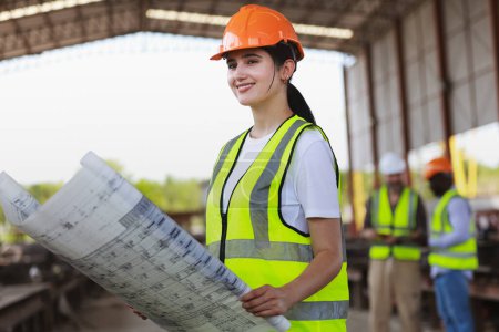 Photo for Closeup Female Civil engineer work with blueprint drawing at construction site - Royalty Free Image