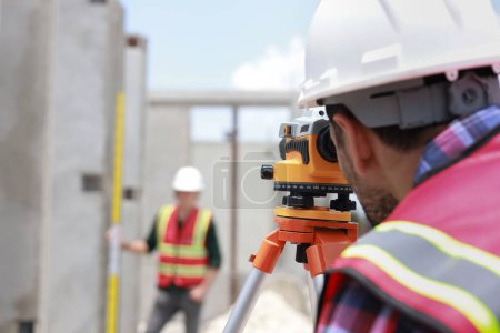 Civil engineer or construction engineer working with survey camera ,Engineer builder with Auto Level camera