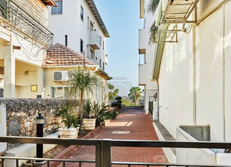Photo for Nice Israeli courtyard with Mediterranean-style residential buildings. - Royalty Free Image