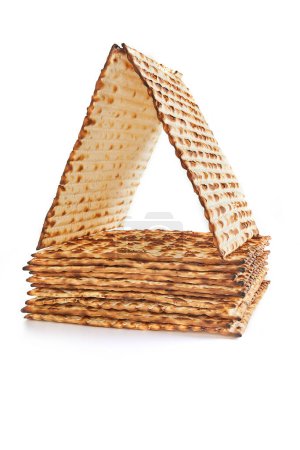 Pesach celebration concept - Jewish holiday Pesach. Stacked matzah isolated on white background. Copy space for text.