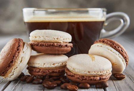 Coffee-Flavored Macarons Piled on Wooden Background with Coffee Cup and Beans.