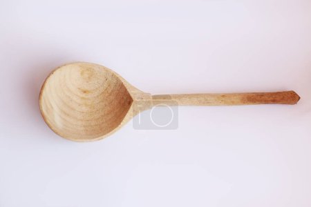 Photo for Wooden spoon in sunlight isolated on white background - Royalty Free Image
