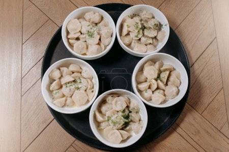 Photo for Traditional pelmeni, ravioli, dumplings filled with meat on plate - Royalty Free Image