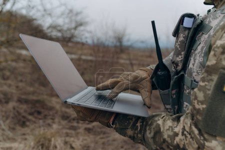 Photo for A soldier works on his laptop. - Royalty Free Image