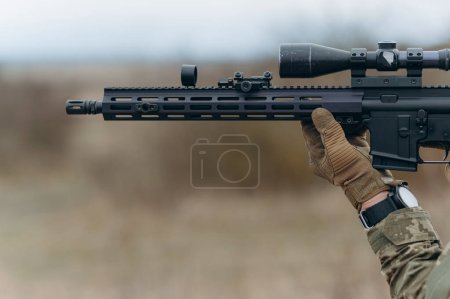 Photo for A machine gun in the hands of a soldier. - Royalty Free Image