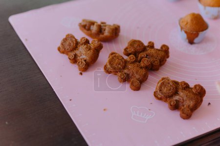 Photo for Chocolate sponge cookies freshly baked on the table. Baking, cookies in the shape of a bear - Royalty Free Image