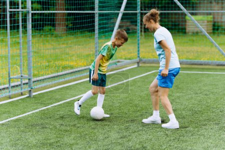 Photo for A girl coach and a boy at football training. - Royalty Free Image