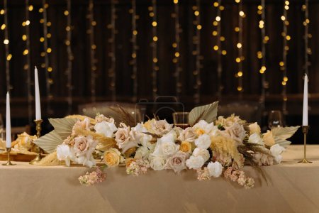 Photo for Boquet of orchid flowers and tulips on arranged table - Royalty Free Image
