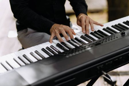 Photo for Man hand playing piano. a man plays the piano. fingers on the keys - Royalty Free Image