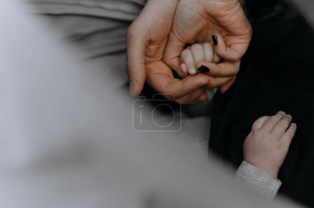 father, mother and child folded their hands. holding hands together. The gesture is a sign of support and love, the unity of the community in relation to the people concept