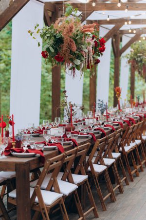 Photo for Wooden tent covered with fabric, wedding banquet. wedding holiday banquet in the open air. covered, served tables in the yard, garden in nature. - Royalty Free Image