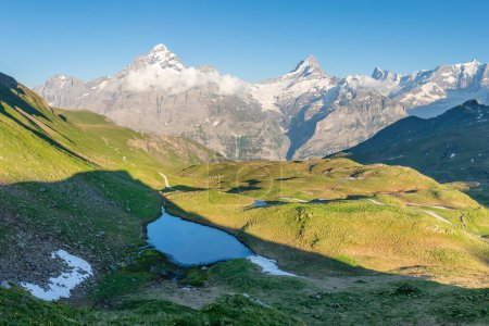 Photo for Panorama of Mt. Schreckhorn and Wetterhorn. Popular tourist attraction. Dramatic and picturesque scene. Place location Bachalpsee in the Swiss Alps Bernese Oberland, Grindelwald, Europe Flowing stream - Royalty Free Image