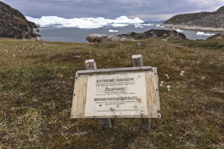 Warning sign about tsunami wave on the fjord shore in Greenland