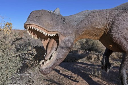 Foto de Moab, Utah, Estados Unidos - 22 de noviembre de 2021: Allosaurus fragilis réplica de dinosaurio con mandíbulas abiertas sobre el rastro de dinosaurios Moab Giants - Imagen libre de derechos