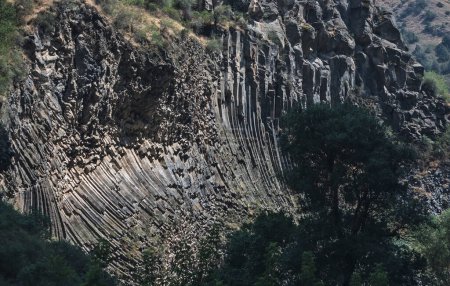 Geological structure known as basalt columnar jointing, with curved and straight columns. Armenia.