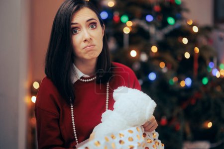 Téléchargez les photos : Femme malheureuse avec son mauvais cadeau de Noël - en image libre de droit