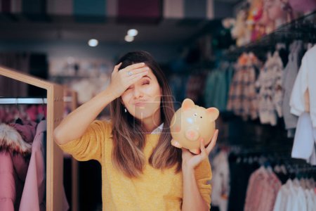Photo for Frustrated Customer Holding a Piggy Bank in a Fashion Store - Royalty Free Image