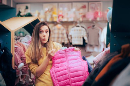 Photo for Surprised Woman Checking Price Tag in a Clothing Fashion Store - Royalty Free Image