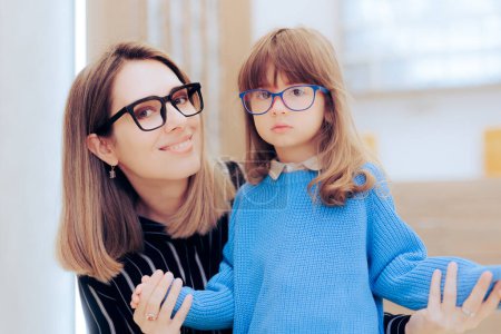 Photo for Mother and Daughter Wearing Eyeglasses in an Ophthalmology Clinic - Royalty Free Image