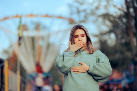Photo for Woman Feels Like Throwing up after Ferris Wheel Ride - Royalty Free Image