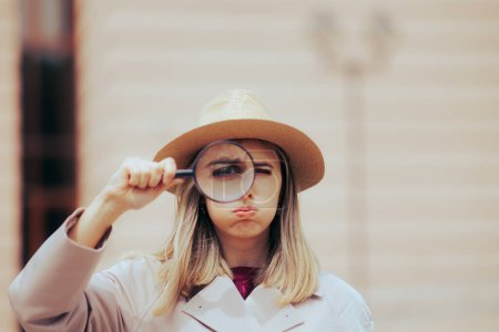 Photo for Detective Woman Wearing a Trench Coat Holding a Magnifying Glass - Royalty Free Image