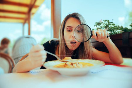 Photo for Picky Eater Inspecting Soup with Magnifying Glass - Royalty Free Image