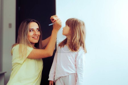 Photo for Mother Measuring her Daughter Checking Developmental Progress - Royalty Free Image