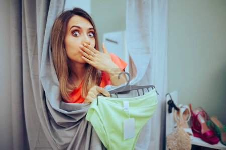 Photo for Funny Woman Trying on panties in a Changing Room - Royalty Free Image