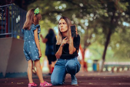 Photo for Mother Scolding her Little Girl for Breaking her Mobile Phone - Royalty Free Image