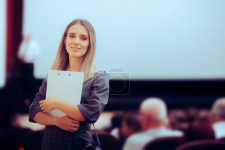 Photo for Happy Woman Holding a Clipboard Attending a Conference - Royalty Free Image