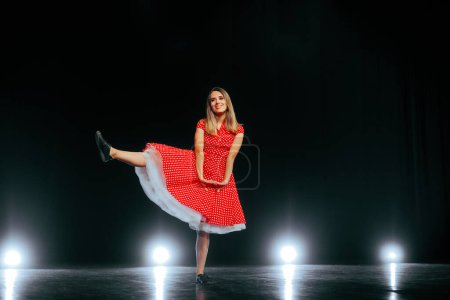 Photo for Happy Dancer Wearing Rockabilly Dress Performing on Stage - Royalty Free Image