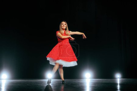 Photo for Happy Dancer Wearing Rockabilly Dress Performing on Stage - Royalty Free Image