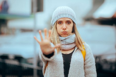 Photo for Woman Wearing Beanie and Winter Clothes Making Stop Gesture - Royalty Free Image