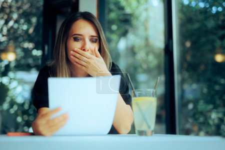 Photo for Unhappy Woman Sitting in a Restaurant Reading a Contract - Royalty Free Image
