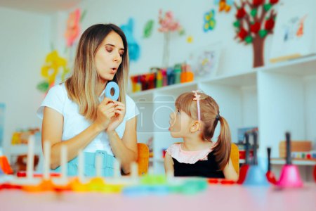 Photo for Speech Therapist Teaching Child How to Pronounce the Letter O - Royalty Free Image