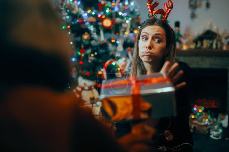 Photo for Ungrateful Woman Refusing a Christmas Gift from a Friend - Royalty Free Image