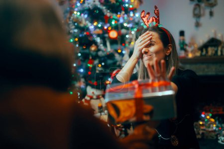 Photo for Ungrateful Woman Refusing a Christmas Gift from a Friend - Royalty Free Image