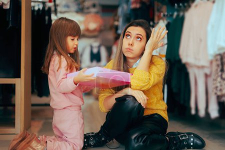 Photo for Daughter Asking Exasperated Mom to Buy Her Toys - Royalty Free Image