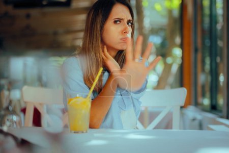 Girlfriend Making Stop Gesture in a Restaurant Across the Table