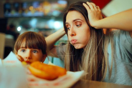 Photo for Desperate Mom Watching her Kid Eating only Fast food Meals - Royalty Free Image