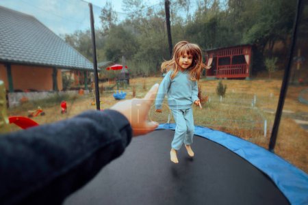Photo for Parent Scolding a Little Hyperactive Kid in a Trampoline - Royalty Free Image